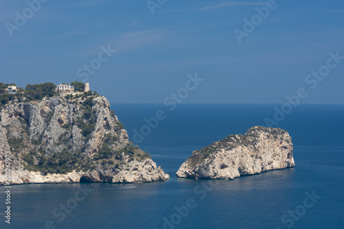 The rocky cliffs in the Cala La Granadella and El descubridor island, Javea, Costa Blanca, Alicante province, Spain