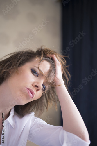Shot of a Caucasian woman getting frustrated at home alone