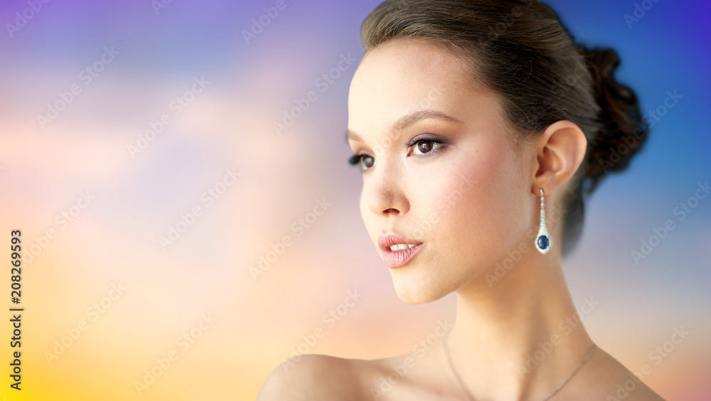 beauty, jewelry, people and luxury concept - close up of beautiful asian woman or bride with earring over pastel background beauty, jewelry, people and luxury concept - close up of beautiful asian woman or bride with earring over pastel background