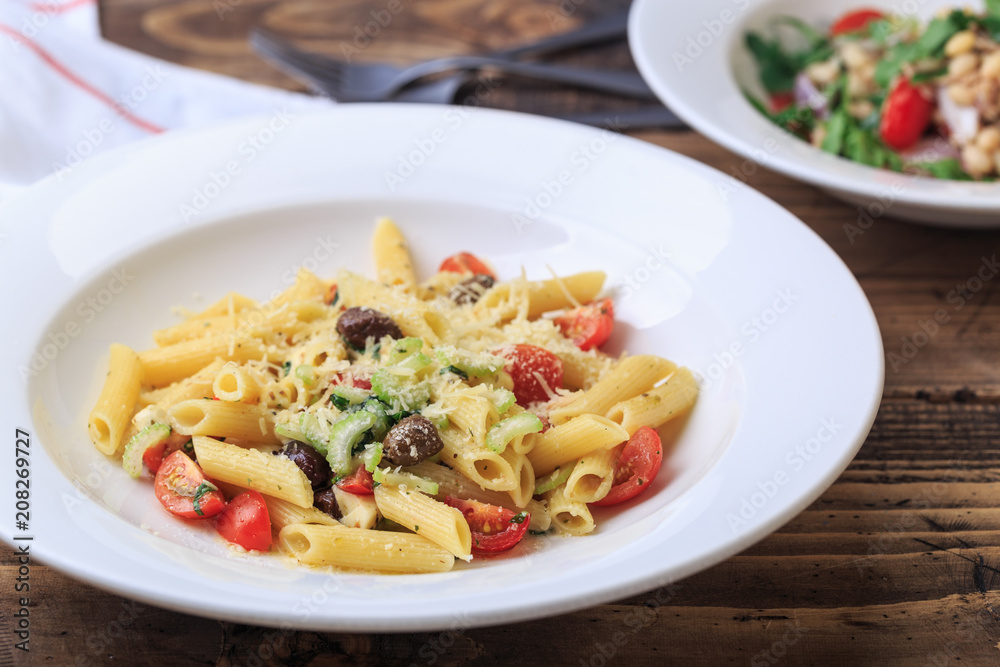 penne with vegetables summer menu wooden background