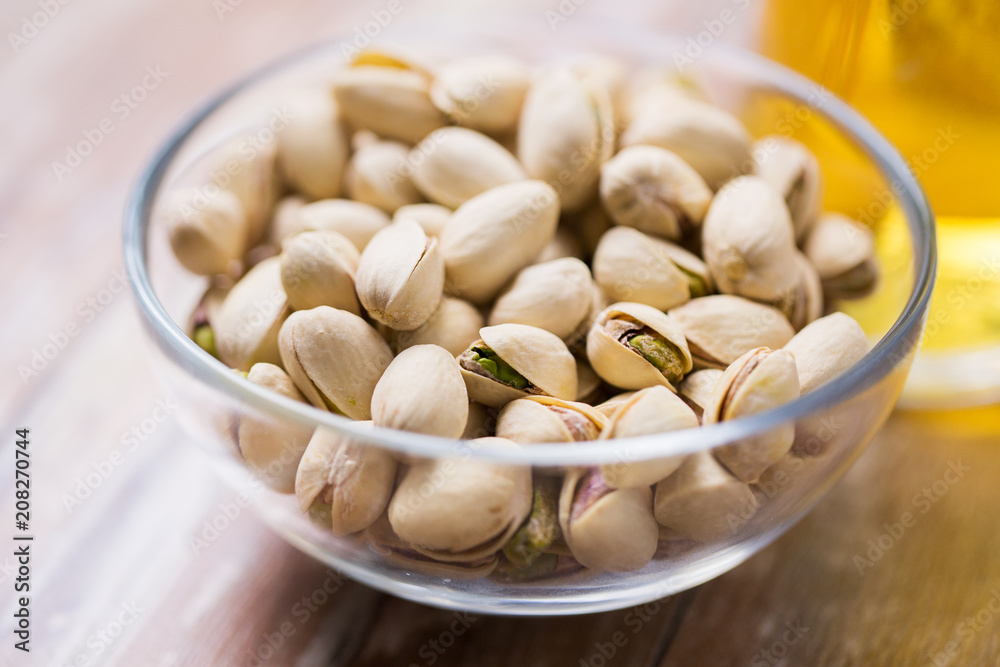food concept - close up of pistachio nuts in glass bowl food concept - close up of pistachio nuts in glass bowl