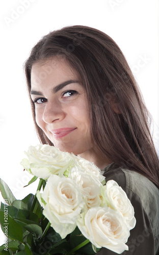 Close up cropped portrait of charming cheerful hispanic woman with natural makeup having bouquet of white roses in hands looking at camera isolated on white background. 
