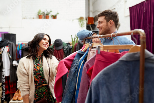 Wallpaper Mural sale, shopping, fashion and people concept - happy couple at vintage clothing store hanger Torontodigital.ca