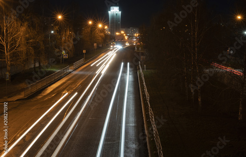 Night city. Light marks on the highway. Blurred motion.