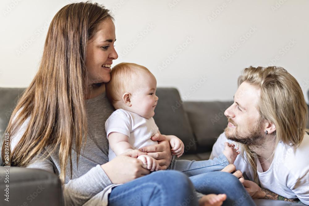 parent with baby daughter on sofa at home parent with baby daughter on sofa at home