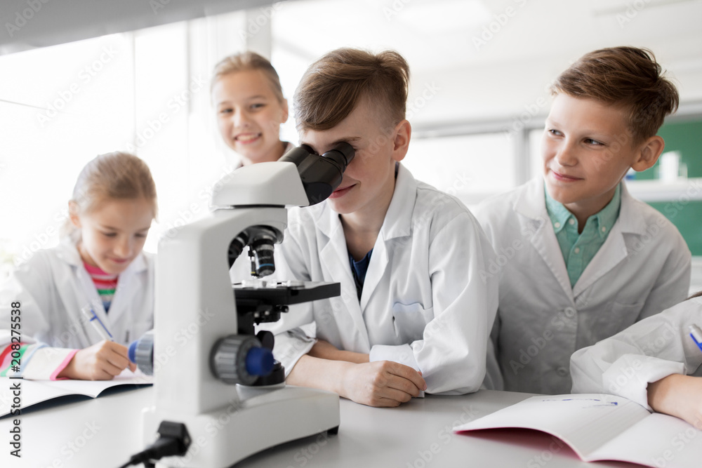 education, science and children concept - kids or students with microscope studying biology at school laboratory education, science and children concept - kids or students with microscope studying biology at school laboratory
