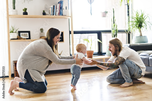 Photos Parent help Baby Daughter Take First Steps At Home