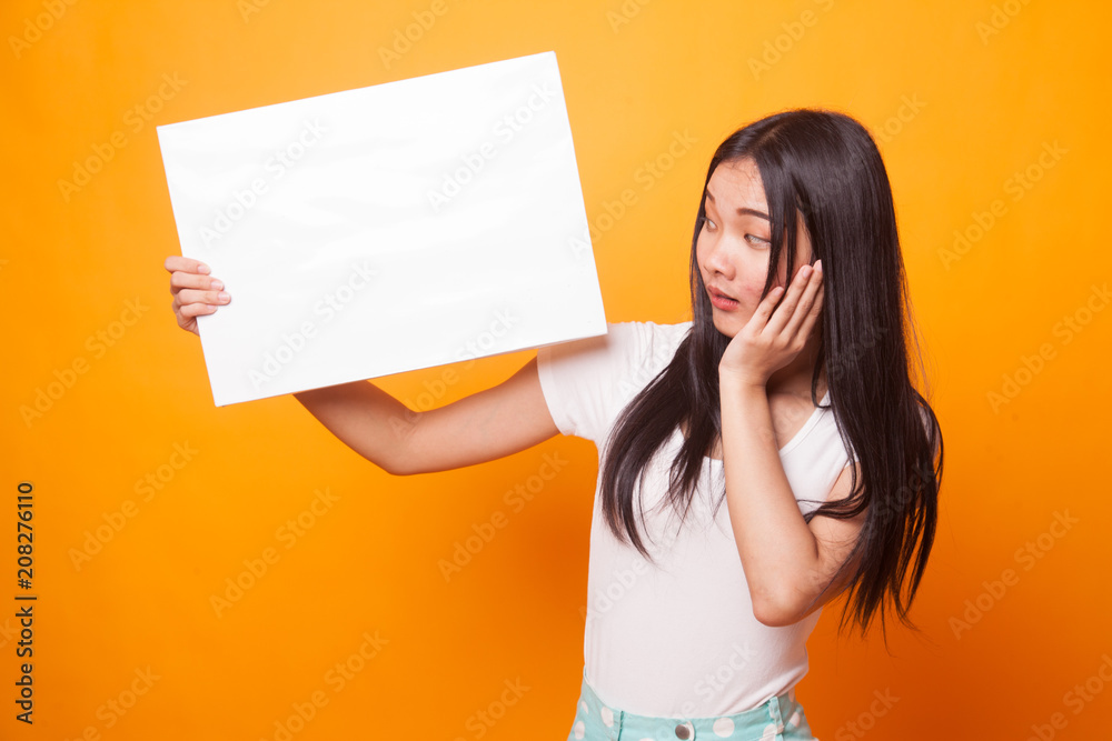 Young Asian woman surprise with white blank sign. Young Asian woman surprise with white blank sign.
