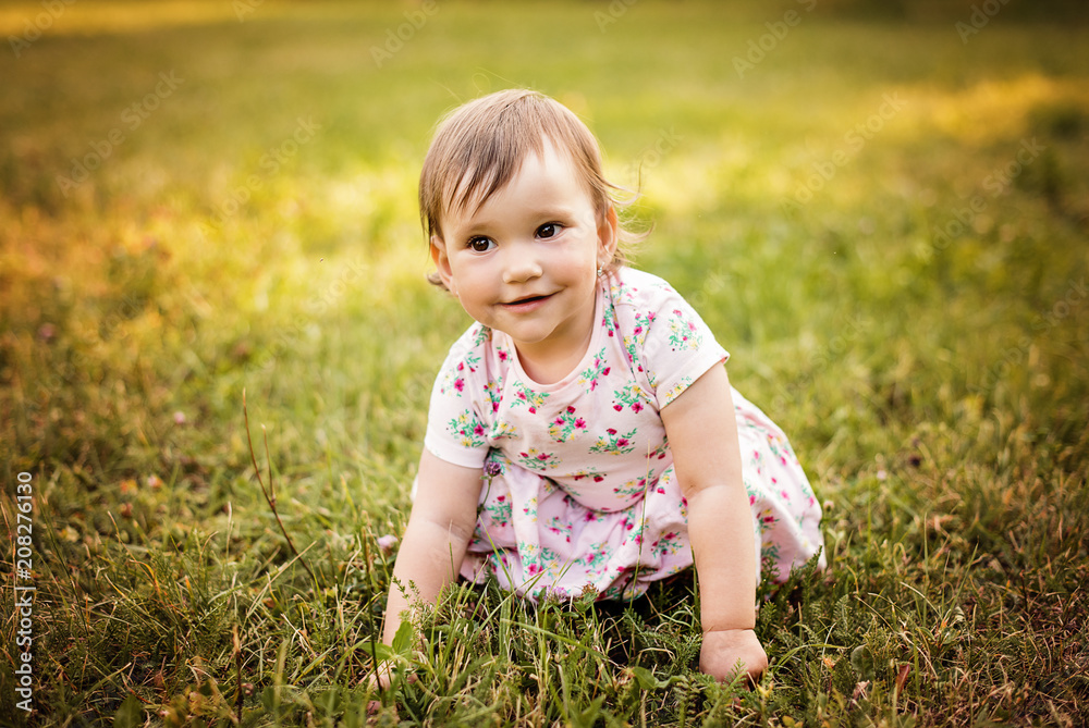 very cute small girl playing outdoors in a park 