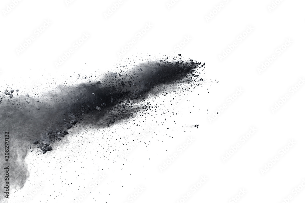 Black powder explosion against white background.Closeup of black dust particles explode isolated on white background.