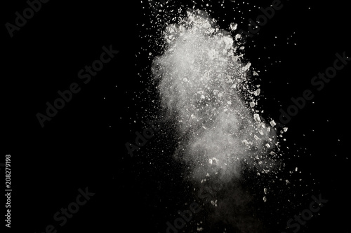 Fototapeta Naklejka Na Ścianę i Meble -  Bizarre forms of  white powder explosion cloud against dark background. Launched white particle splash on black background.