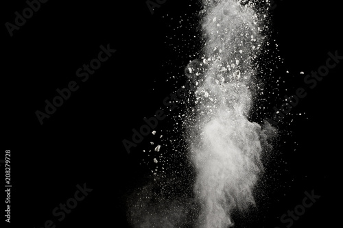 Bizarre forms of of white powder explosion cloud against dark background.Launched white dust splash on black background.