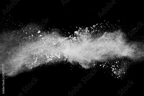 Bizarre forms of of white powder explosion cloud against dark background.Launched white dust splash on black background.