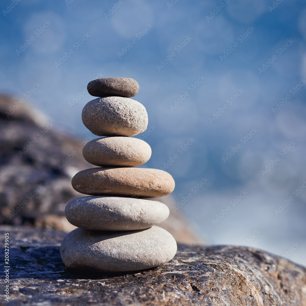 Balanced stone on a peddle beach during sunset. Balanced stone on a peddle beach during sunset.