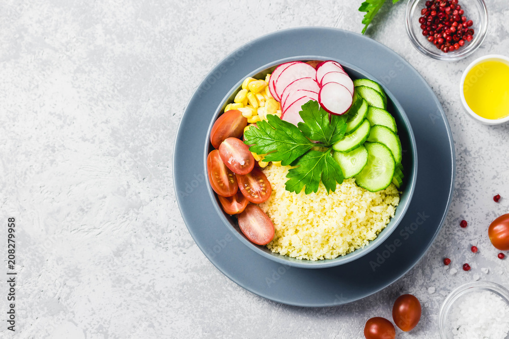 Vegan couscous summer vegetables buddha bowl. Top view, space for text.