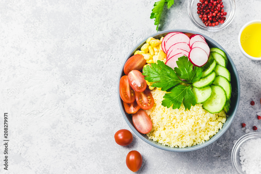 Vegan couscous summer vegetables buddha bowl. Top view, space for text. Vegan couscous summer vegetables buddha bowl. Top view, space for text.