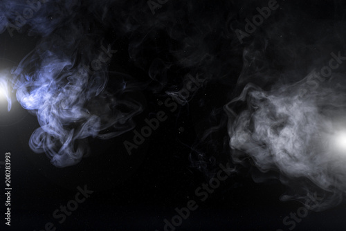 grey smoky swirls and lights on black background with copy space