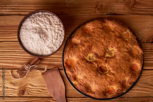 apricot pie and a bowl with flour and other ingredients and tools table