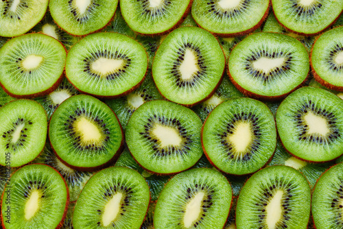 top view of heap of sliced kiwi as textured background
