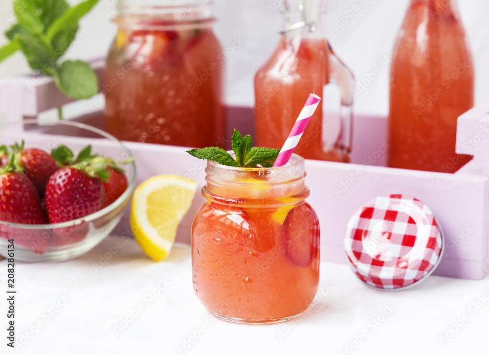 Retro glass jar of detox water with strawberries, lemon and mint Retro glass jar of detox water with strawberries, lemon and mint