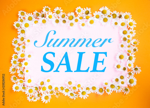 Summer Sale written on pink and orange background with daisies