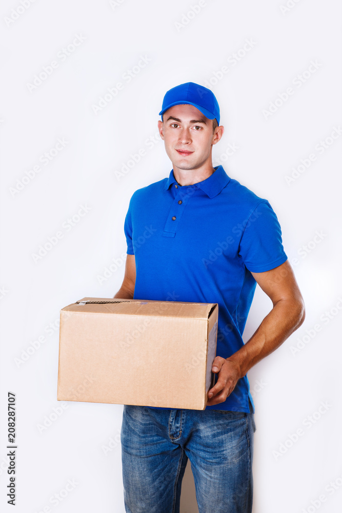 Cheerful delivery man. Happy young courier holding a cardboard box and smiling Cheerful delivery man. Happy young courier holding a cardboard box and smiling