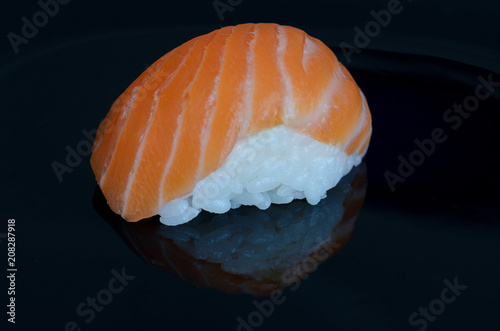 Sushi salmon on black background. Minimalist Japanese food concept. Copy space.