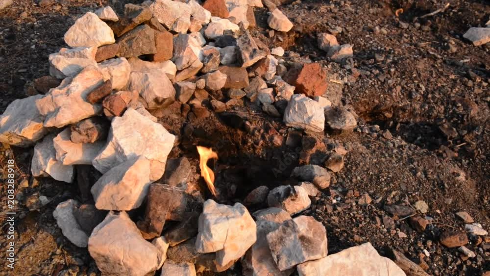Chimaera flames among the rocks next to green grass and trees. Lycian way, Turkey Chimaera flames among the rocks next to green grass and trees. Lycian way, Turkey