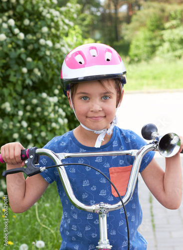 Happy Caucasian child on a bicycle.