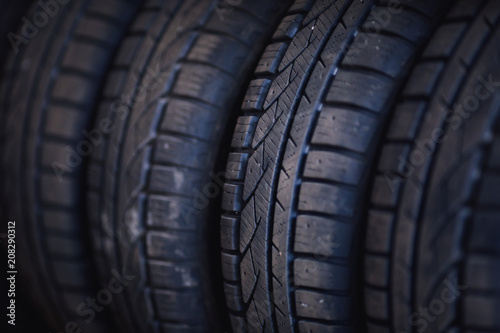 Protector of automobile tires. A number of automobile tires. Close up view on auto mobile new wheel tire surface. Different pattern and type tires for car industry commercial transport transpotration © kucheruk