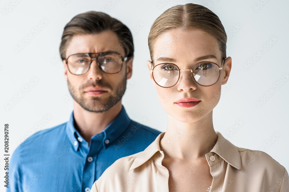 close-up portrait of attractive young man and woman in stylish clothing and eyeglasses isolated on white - obrazy, fototapety, plakaty 