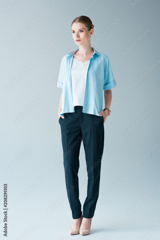 attractive young woman in stylish clothing on grey attractive young woman in stylish clothing on grey