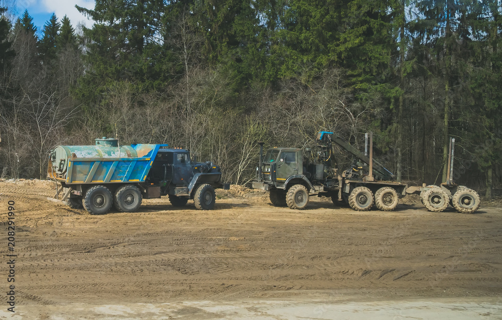 Obraz premium Tank truck and Logging truck in the forest.