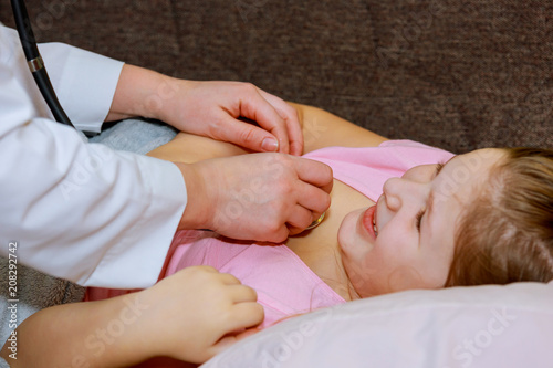 Doctor examining little girl with stethoscope the hospital healthcare and medicine