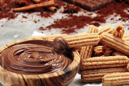 Traditional Spanish dessert churros with sugar and chocolate