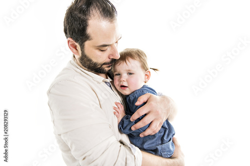 A Close up portrait of handsome father holding his crying daughter