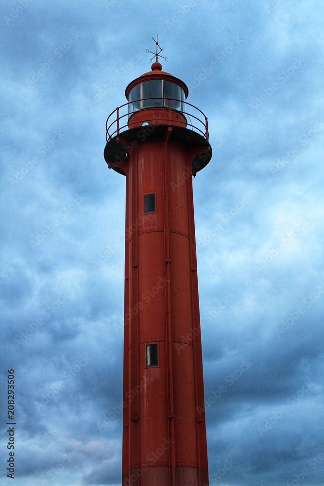 Red lighthouse in the port of Cacilhas village in Lisbon