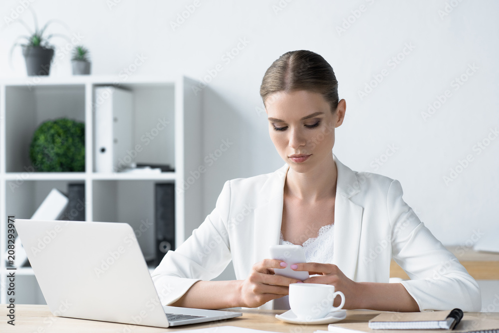 beautiful young businesswoman using smartphone at office beautiful young businesswoman using smartphone at office