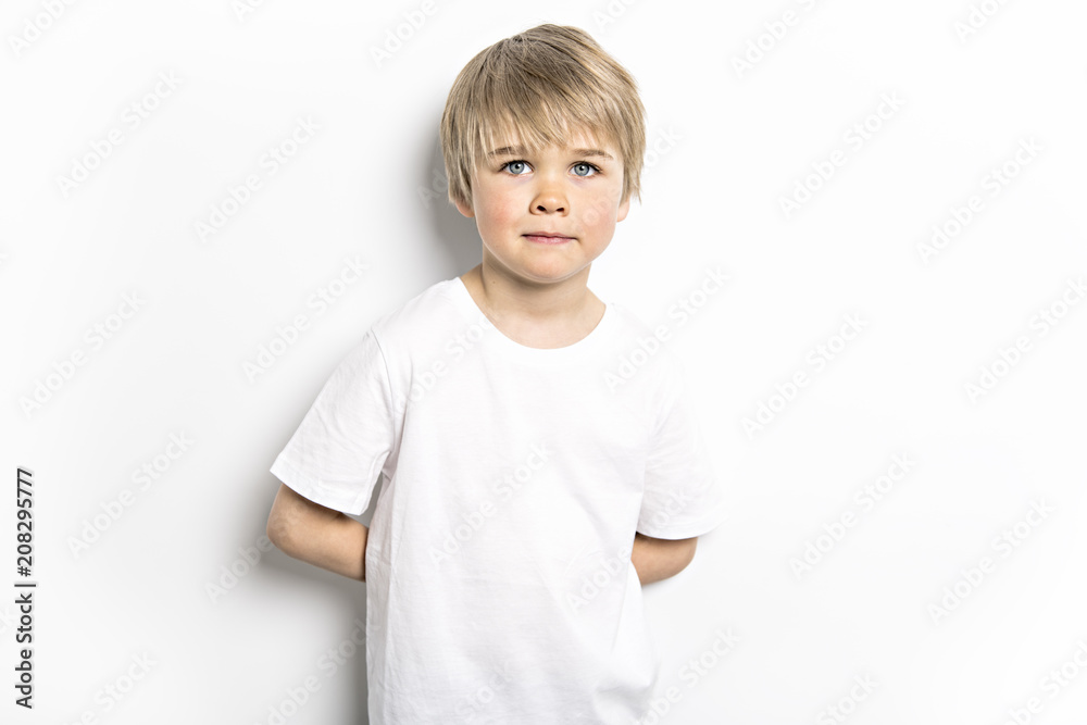 cute five year old boy studio portrait on white background