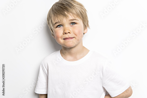 cute five year old boy studio portrait on white background