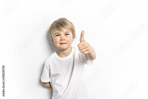 cute five year old boy studio portrait on white background