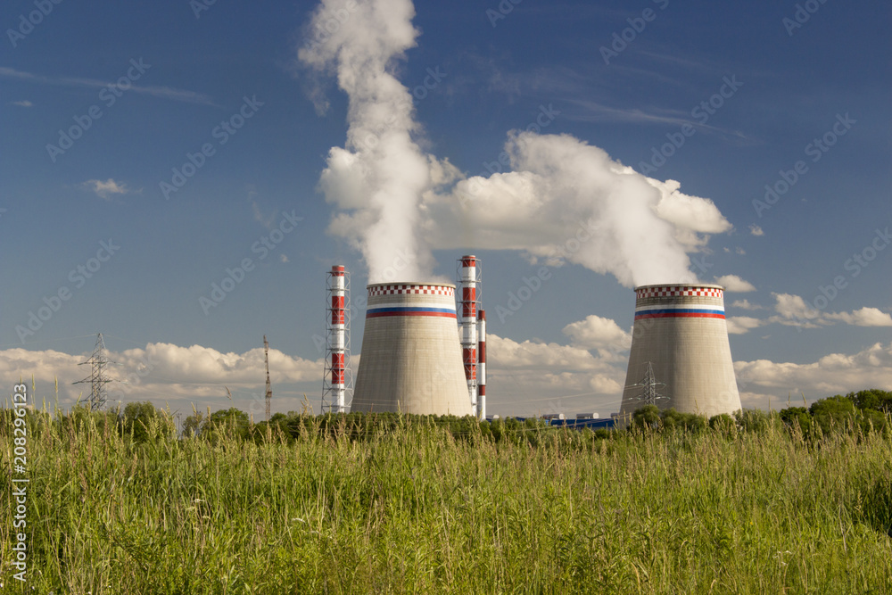 power plant pipes on the background of green grass, ecology