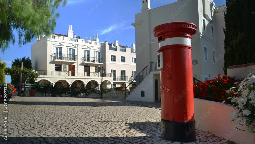Timelapse of UK red letter pillbox bollard at the Old Village, a tranquil setting in The Algarve, surrounded by the Pinhal Golf Course and close to pristine beaches Timelapse of UK red letter pillbox bollard at the Old Village, a tranquil setting in The Algarve, surrounded by the Pinhal Golf Course and close to pristine beaches