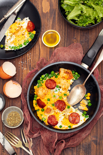 mixed egg with potato  peas and smoked sausages
