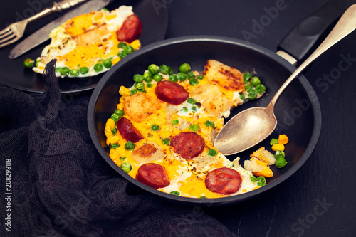 mixed egg with potato, peas and smoked sausages