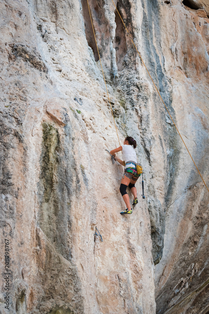 Young woman rock climbing on white mountain Young woman rock climbing on white mountain