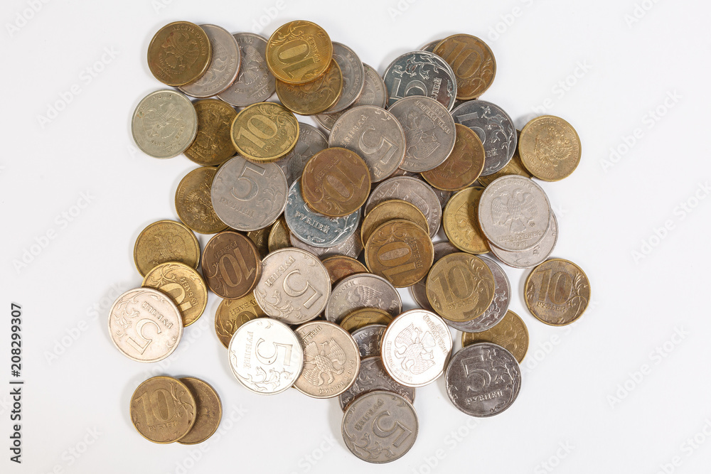 a bunch of Russian coins on a white background of five and 10 rubles. a bunch of Russian coins on a white background of five and 10 rubles.