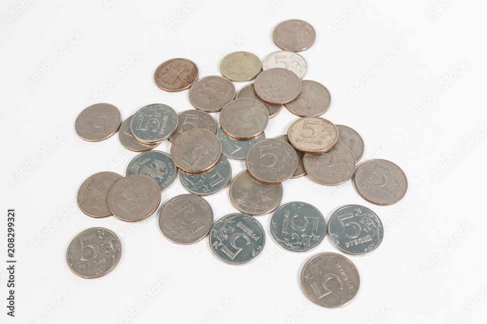 a bunch of Russian coins on a white background of five rubles. a bunch of Russian coins on a white background of five rubles.