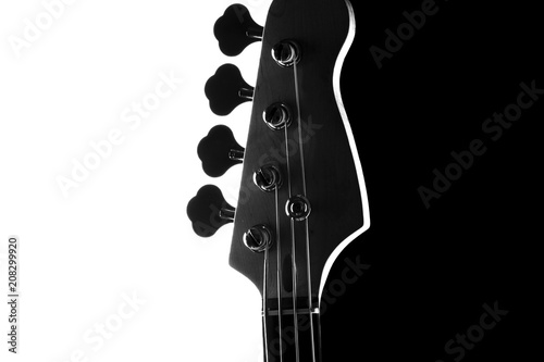 Fotografie Silhouette of an electric bass guitar on a contrasting black and white background