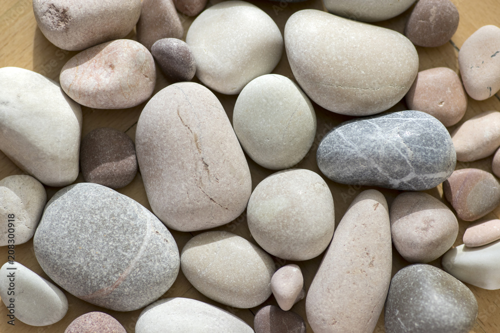 Group of pebbles, light colors, stone background, round and smooth pebbles, simple and harmony texture Group of pebbles, light colors, stone background, round and smooth pebbles, simple and harmony texture